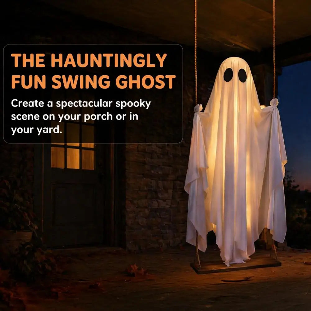 A hanging swing ghost Halloween decoration glowing with warm white lights, shown outdoors in front of a stone building at dusk. Text on the left reads 'THE HAUNTINGLY FUN SWING GHOST' and 'Create a spectacular spooky scene on your porch or in your yard.